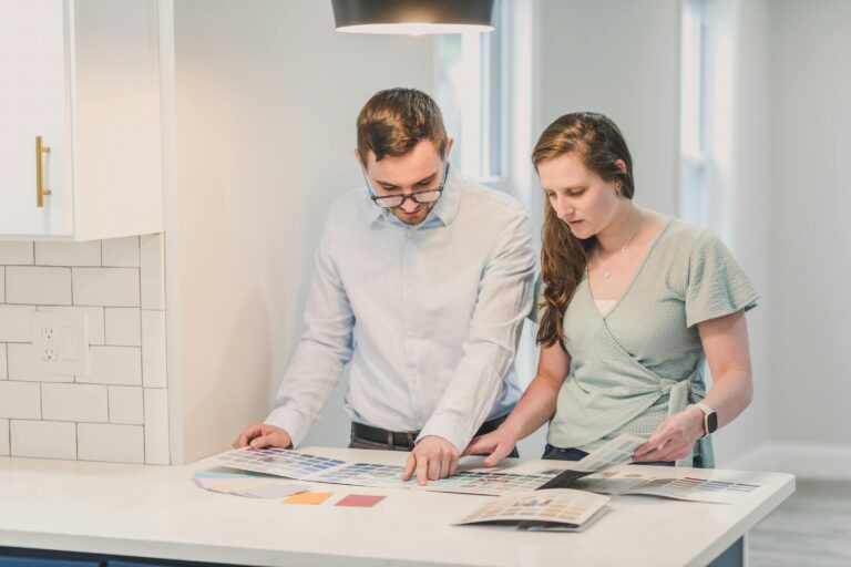A couple selecting color swatches for home decoration, symbolizing planning and collaboration.